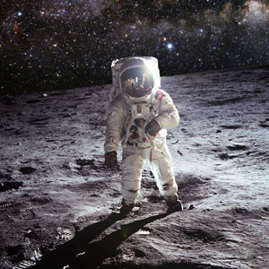 Astronaut Neil Armstrong standing on moon with Photoshopped galaxy in the sky above